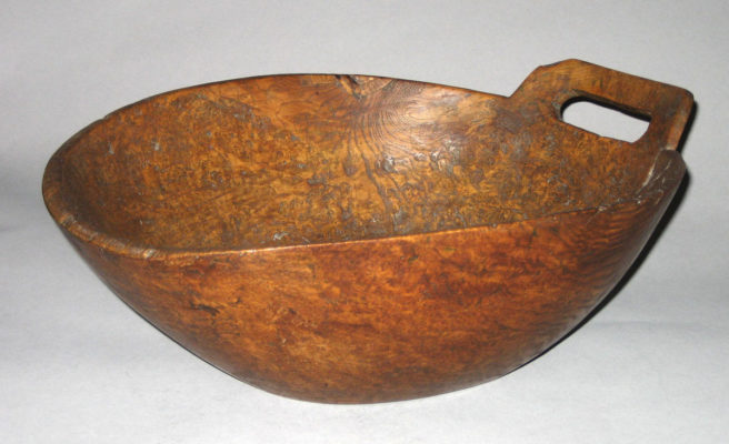 Side view of wooden bowl with one handle