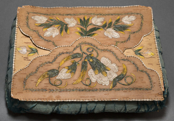 Detail of the top of the case with floral embroidery