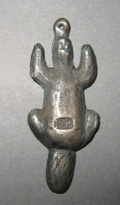 metal beaver pendant with impressed "DE" on its back